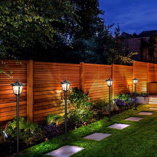 A decorative horizontal cedar fence with a hardscaped back yard